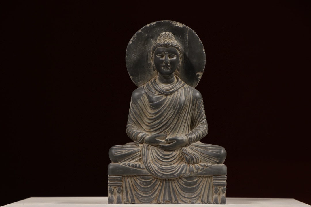 A Gandhara-style stone-carved seated Buddha statue: Name A Gandhara-style stone-carved seated Buddha statue Dimensions H:38cm W:24cm Description