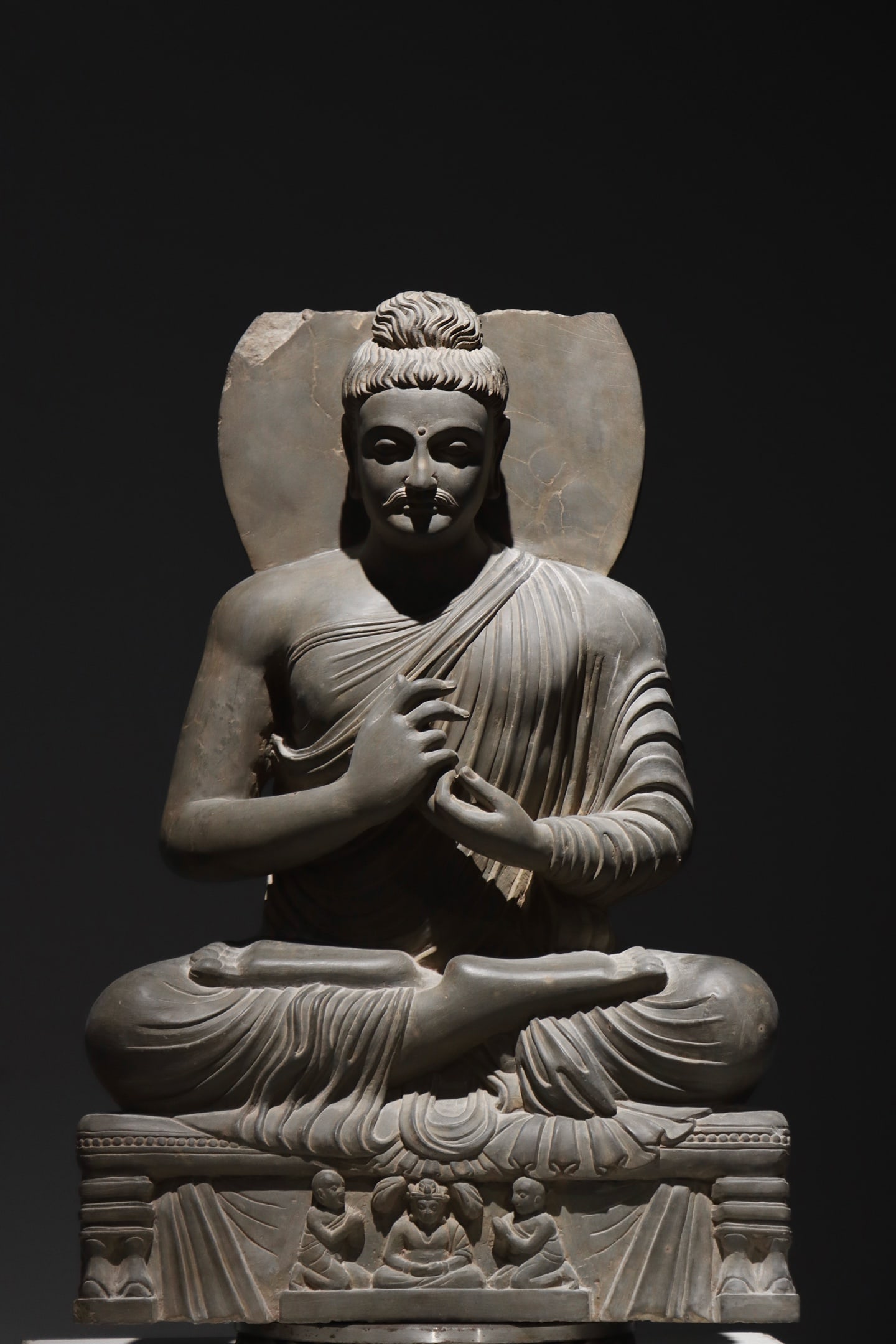 A Gandhara-style stone-carved seated Buddha statue (1 of 9)