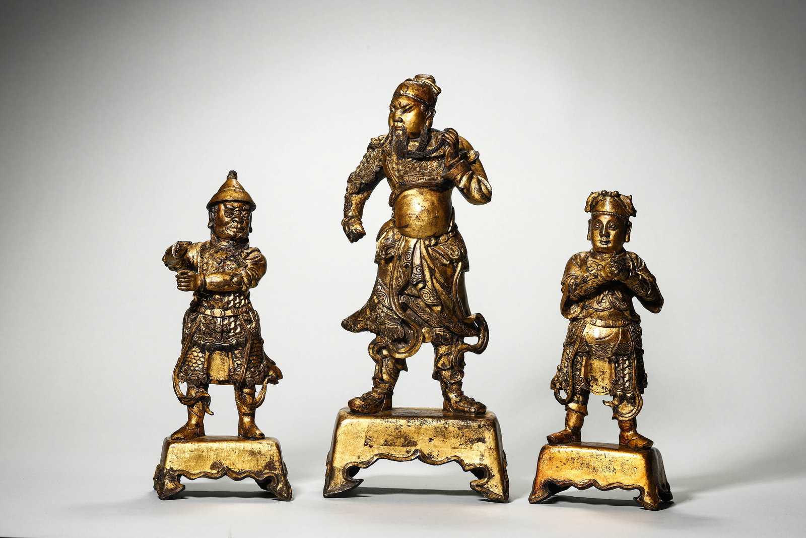 Ming Dynasty, Set of Gilt Bronze Statues of Guan Yu, Zhou Cang and Guan Ping: Name Ming Dynasty, Set of Gilt Bronze Statues of Guan Yu, Zhou Cang and Guan Ping Dimensions H:34cm/H:24.5cm/H:25.5cm Description