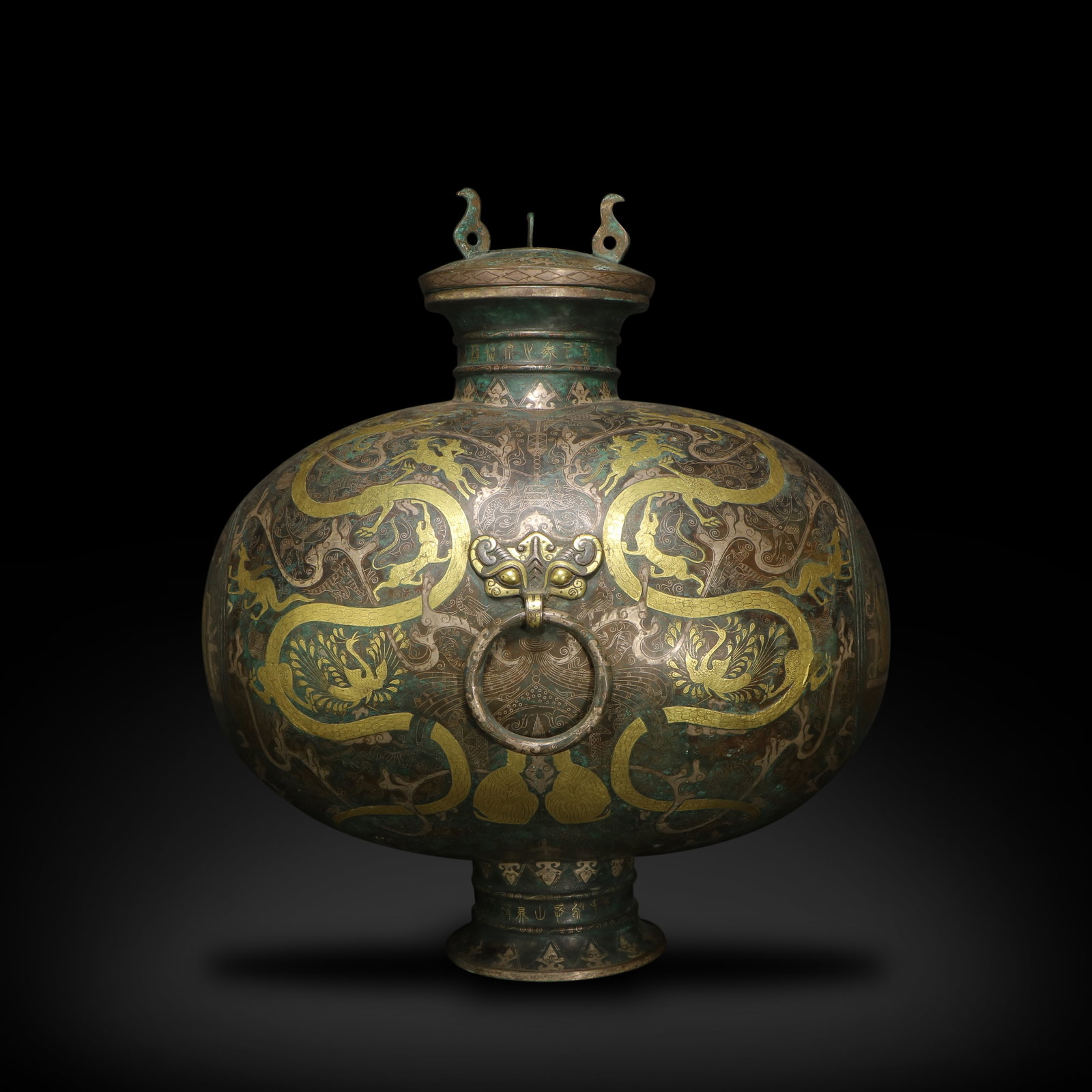 Warring States Period Bronze cocoon-shaped wine vessel with mythical beast and figure patterns: Name Warring States Period Bronze cocoon-shaped wine vessel with mythical beast and figure patterns inlaid with gold and silver Dimensions H:42.5cm W:28.6cm Description