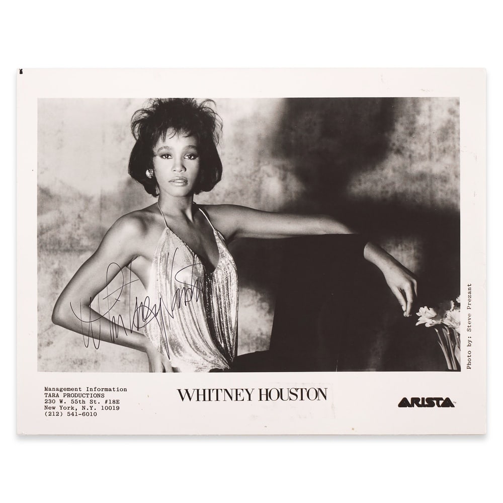 WHITNEY HOUSTON, SIGNED PROMOTIONAL PHOTOGRAPH: 10 x 8 1/8 in (25.5 x 20.5 cm) Provenance and Authentication: This collectible has undergone a rigorous forensic evaluation. The signatures were carefully analyzed across multiple criteria, including
