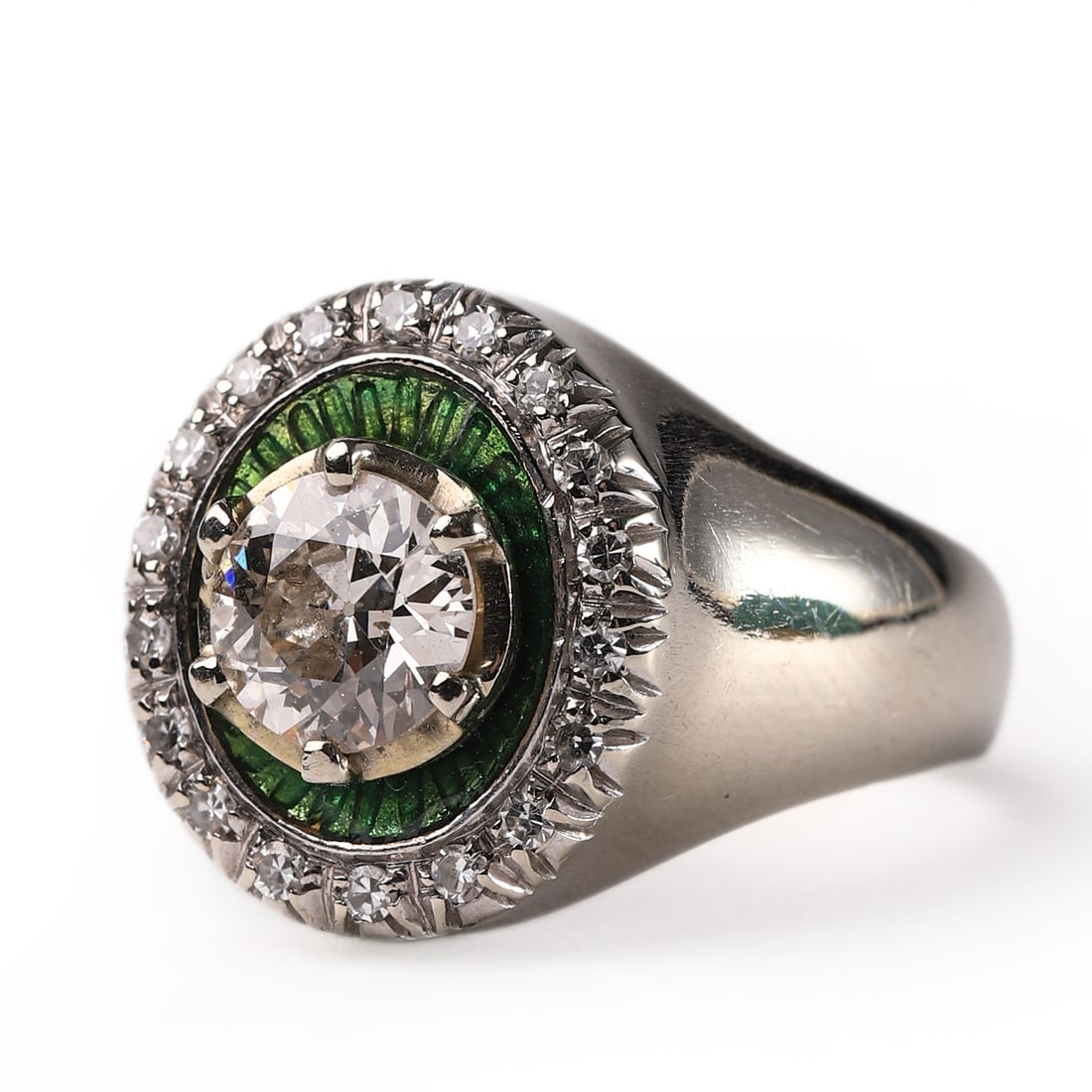 18K GOLD DIAMOND RING WITH GREEN ENAMEL ACCENTS: Dimensions: Face diameter: 1/4 in. (6.4 mm), Inner diameter: 11/16 in. (17.6 mm), Weight: 7.9 g This striking 18K gold ring features a brilliant-cut central diamond encircled by a vibrant green