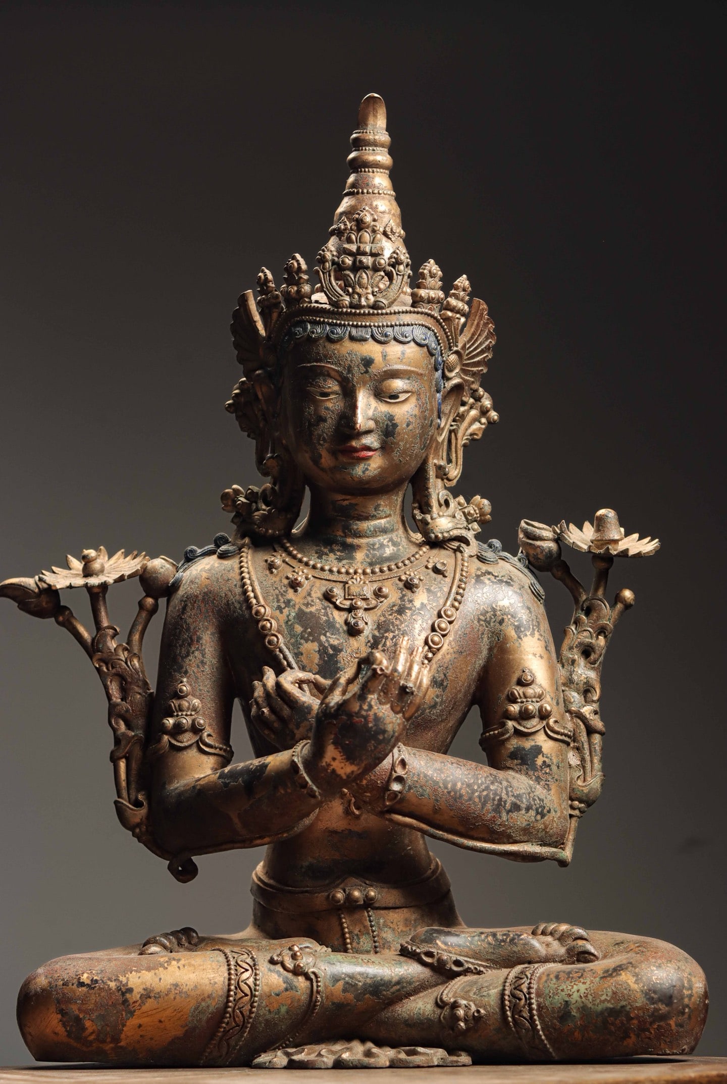 A GILDED BRONZE SEATED STATUE OF MANJUSRI BODHISATTVA FROM THE MING DYNASTY: Weight: 12300gH: 62cmW: 40cmT: 22cm Manjusri Bodhisattva is regarded as the embodiment of the wisdom of all Buddhas. He often appears in the image of holding a scripture and a sword, symbolizing the e
