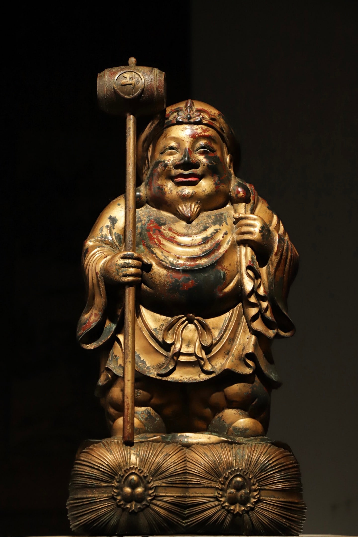 GILDED BRONZE MAHAGARAS FROM THE QING DYNASTY: Weight: 17000g, H: 52.5cmW: 25cmThis is a gilt-bronze standing statue of Daikokuten (or Budai Monk/God of Wealth). Made of gilt bronze, it has a round and joyful face, a exposed belly, holding a treas