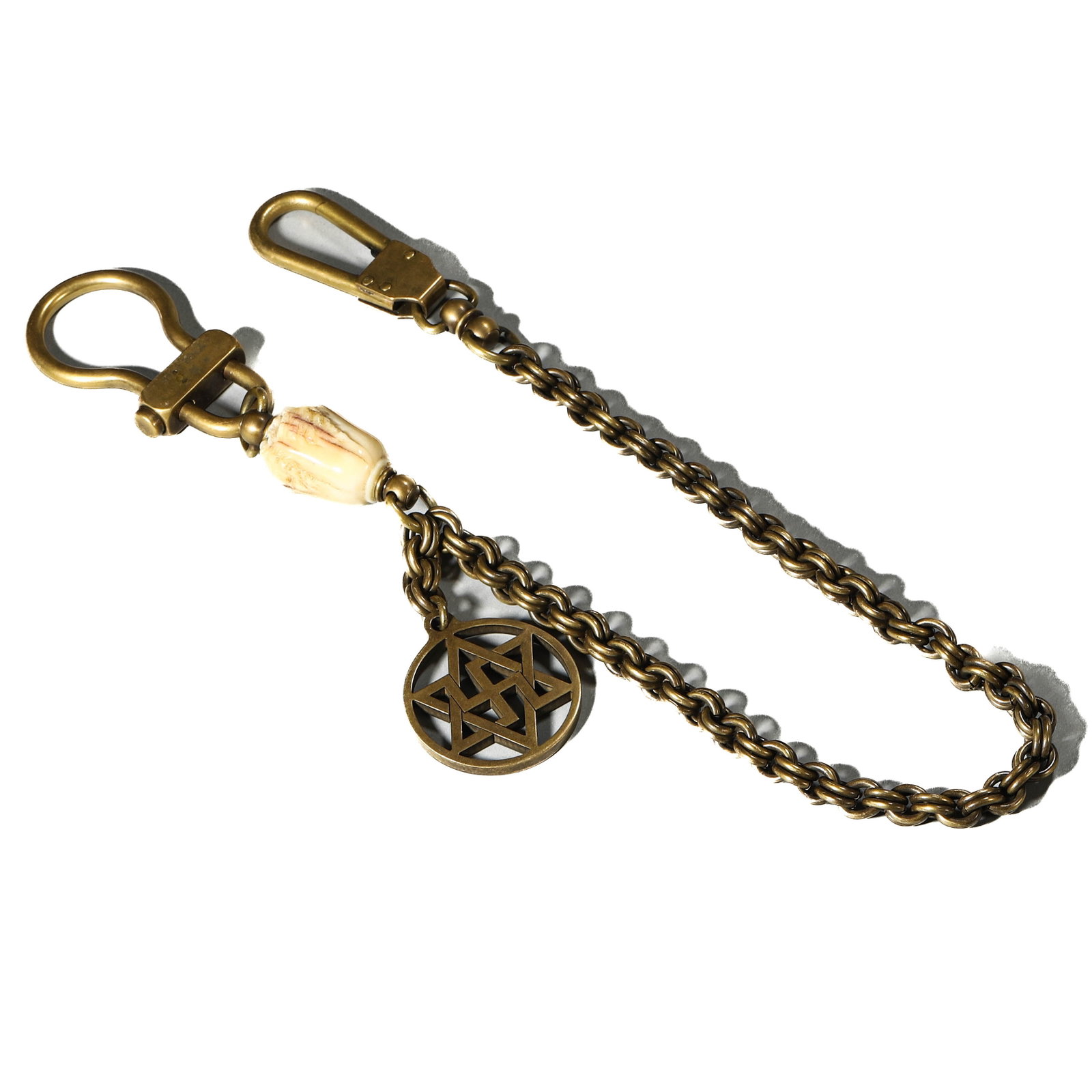 A BRASS WATCH CHAIN WITH PENDANT AND TOOTH ELEMENT: Dimensions Length: 21 1/2 in (54.5 cm) Description The brass chain features a double clasp, one engraved with YNR.1945 flanked by stars. Suspended from the chain is a carved tooth element, likely deer
