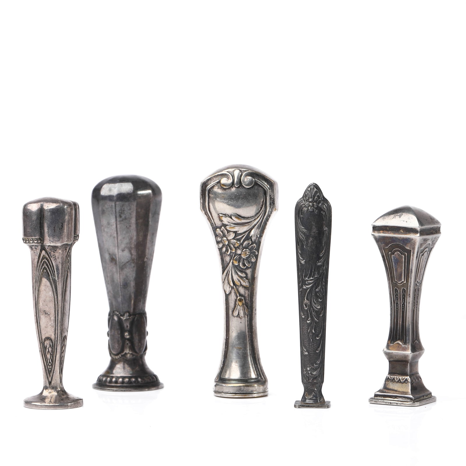 A SET OF FIVE ANTIQUE SILVER-TONED WAX SEAL STAMPS: Dimensions tallest 3 5/8 in (9.2 cm); smallest 3 1/32 in (7.7 cm); total weight approx. 125.6 g Description This assembled group comprises five antique silver-toned wax seal stamps, each with distinct
