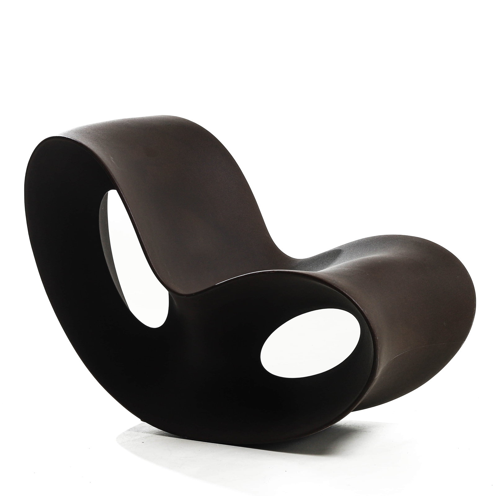 A CONTEMPORARY SCULPTURAL ROCKING CHAIR: Dimensions Height 30 7/8 in (78.5 cm); Width 22 1/2 in (57 cm); Length 43 1/4 in (110 cm). Description Of bold sculptural form, the chair is crafted in a continuous undulating silhouette with fluid
