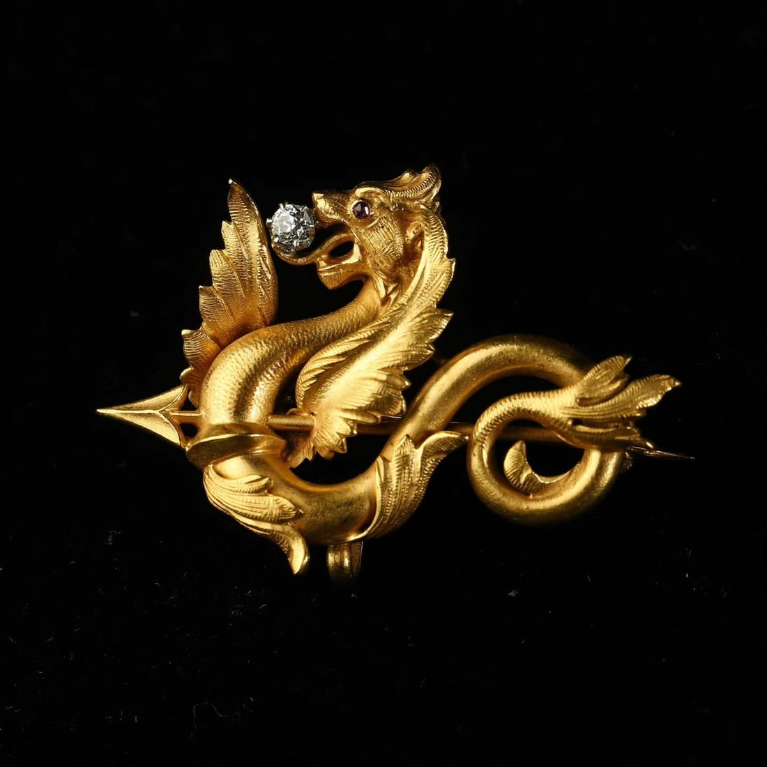 Art Nouveau Period (1880-1920) French Antique Chimera Dragon 23K Gold Diamond and Ruby-Set Brooch: 4*2.8cm Wt:7.8g Entirely hand-crafted in 23K gold, modelled as a fully-rounded sculpted winged-dragon Chimera. It boasts fluid lines and powerfully dynamic contours. An old-cut diamond is held within 