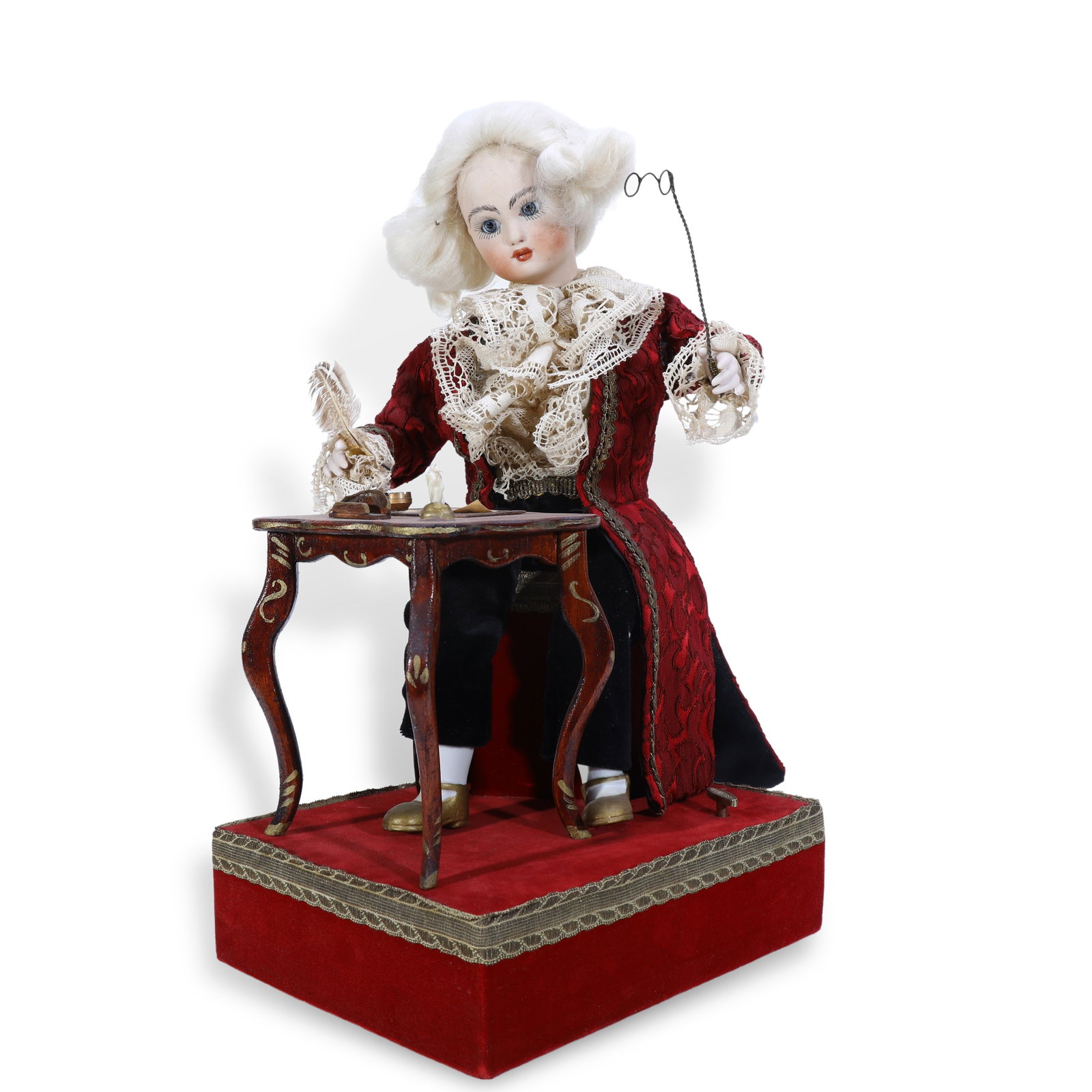 19th Century Musical Automaton of a Scribe Writing with Brush: H:38cm W:21cm After winding up to activate the music, the figure performs a full set of coordinated movements:its head turns left and right, the right hand holds and manipulates a quill pen, while