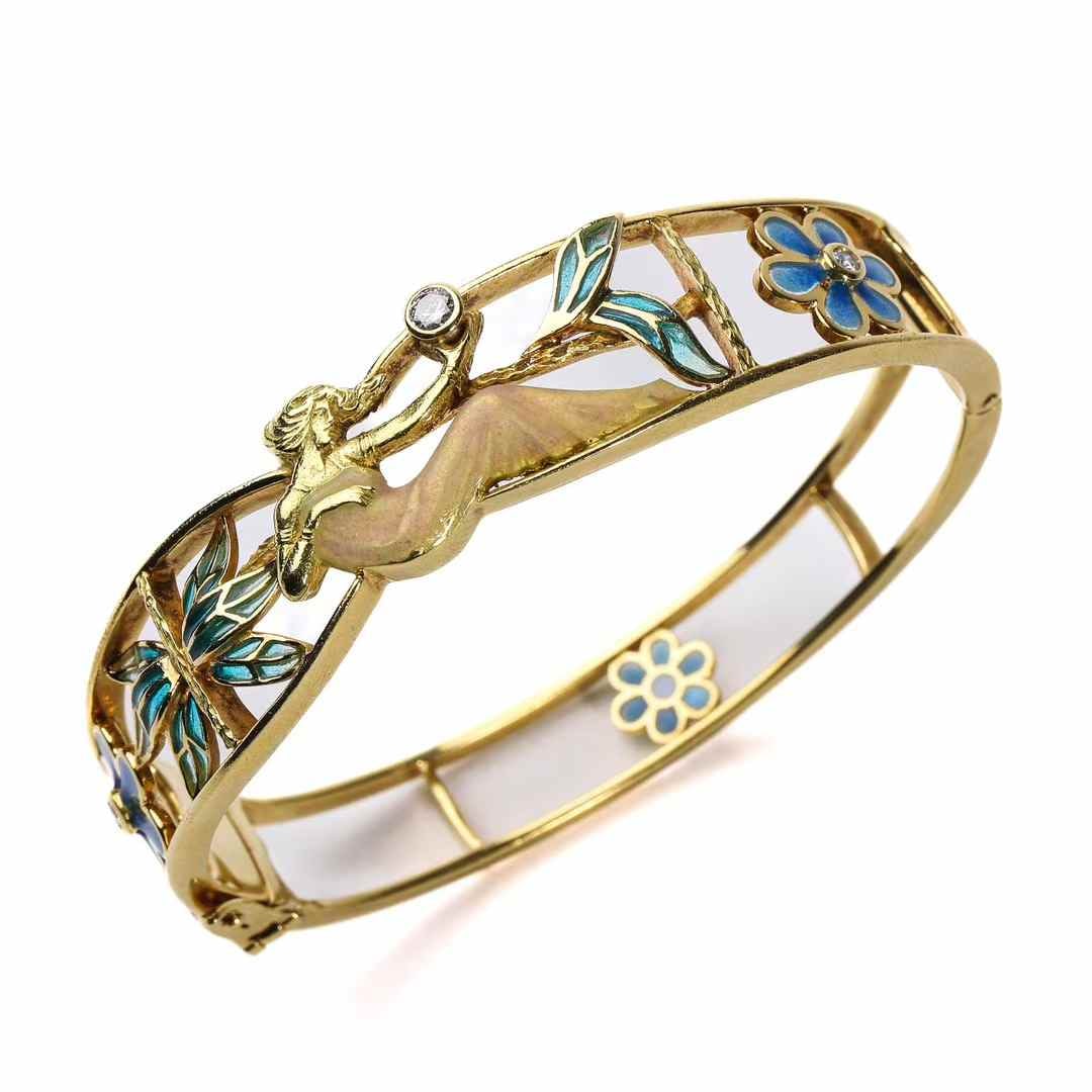 Masriera 18K Gold Semi-Translucent Enamel Maiden-and-Floral-Motif Bangle: Bracelet inner diameter 51-58 mm Wt:34.2g Entirely hand-crafted in 18K gold, this piece features Masriera's signature translucent graduated enamel and plique-a-jour enamel, two of the most technically