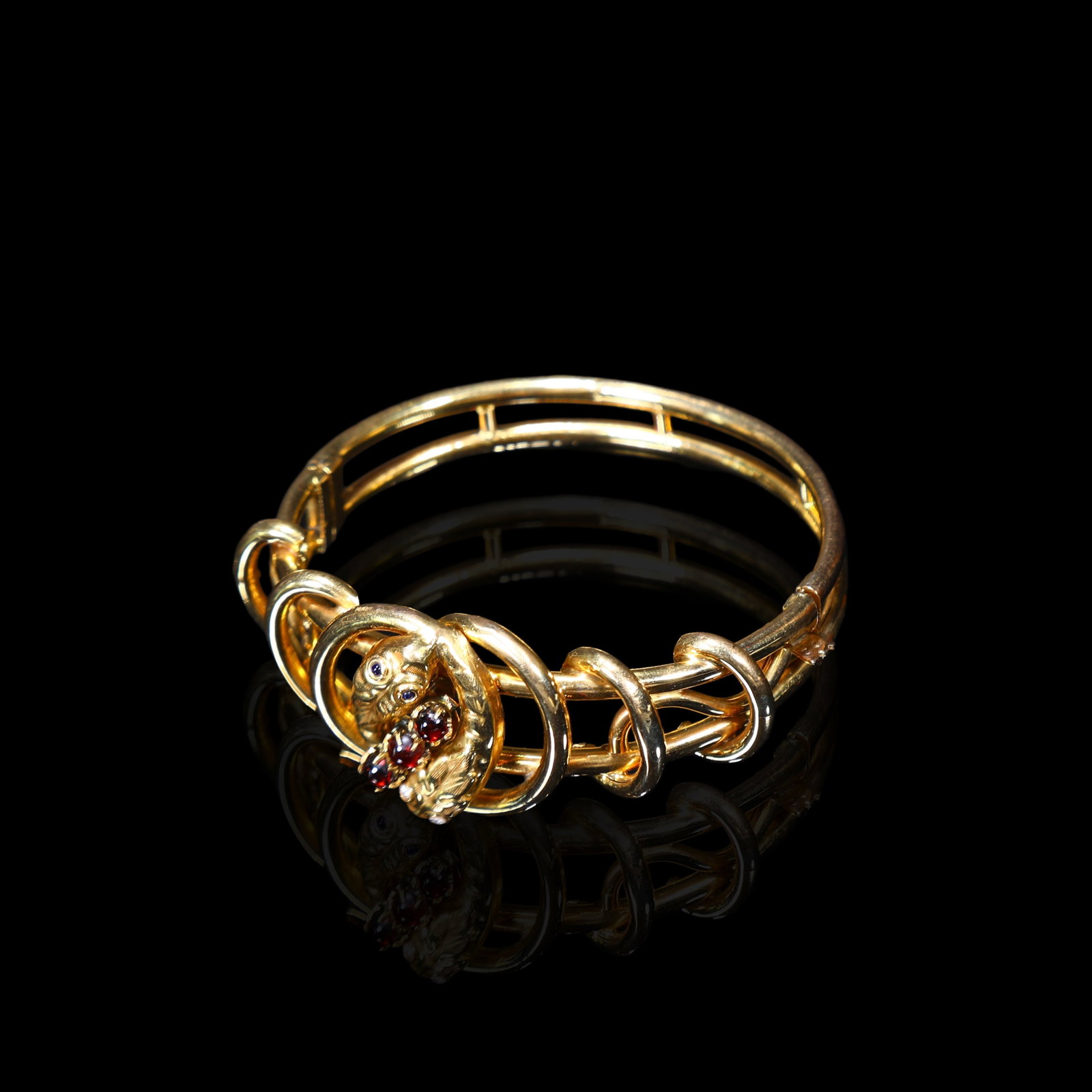Late-Victorian to Early-Edwardian British 14K Gold Double-Snake Bangle Set with Diamonds and: Inner Length:18.5cm Bracelet Width:2.7cm Wt:26.17g Metal: 14K gold. Two diamonds and two sapphires, each measuring 2 mm. Three slightly larger garnets at 4 mm.