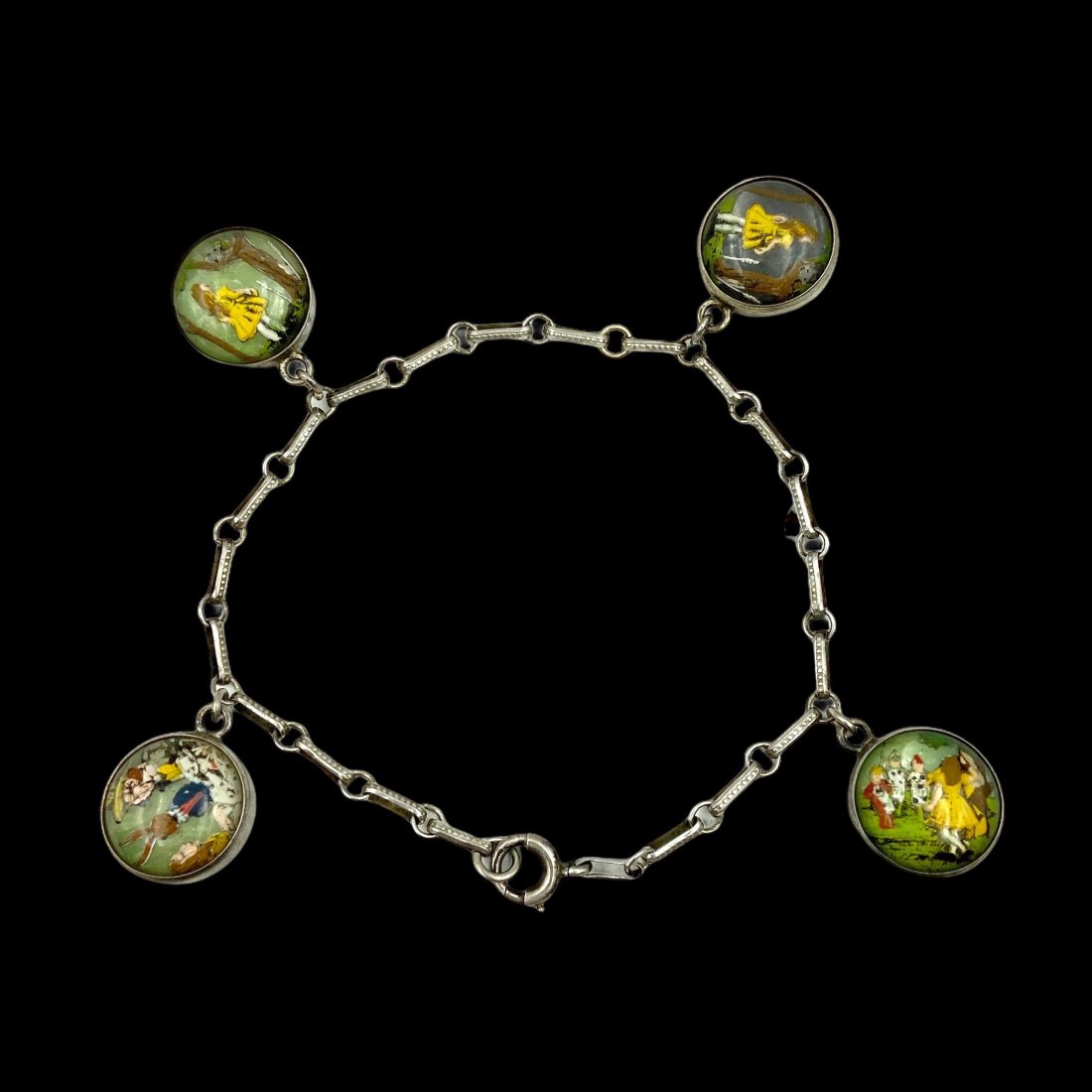 Rare Alice in Wonderland Essex Crystal Charm Bracelet: Early 20th Century. Very rare double sided Essex Crystal charm bracelet depicting Alice in Wonderland. Amazing color and detail. Settings and chain in sterling. Each crystal measures 12mm Dia. Bracele