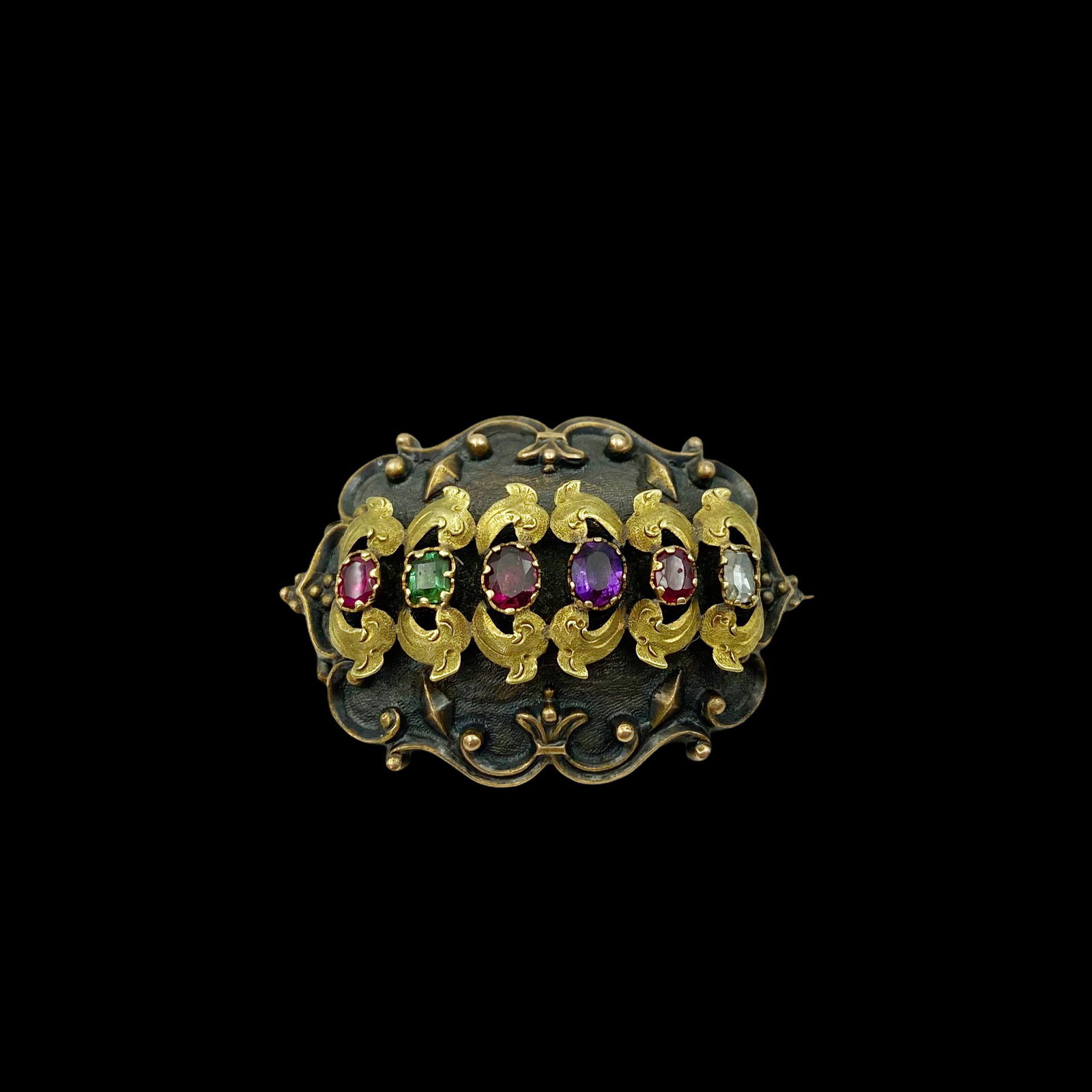Victorian Gold Gem Set Regard Pin Locket: 14K. With genuine ruby, emerald, garnet, amethyst, ruby, and diamond to spell out REGARD. Locket verso. Measures 1 1/2 in W. x 1 in T. Weight 7.9g. Excellent condition.