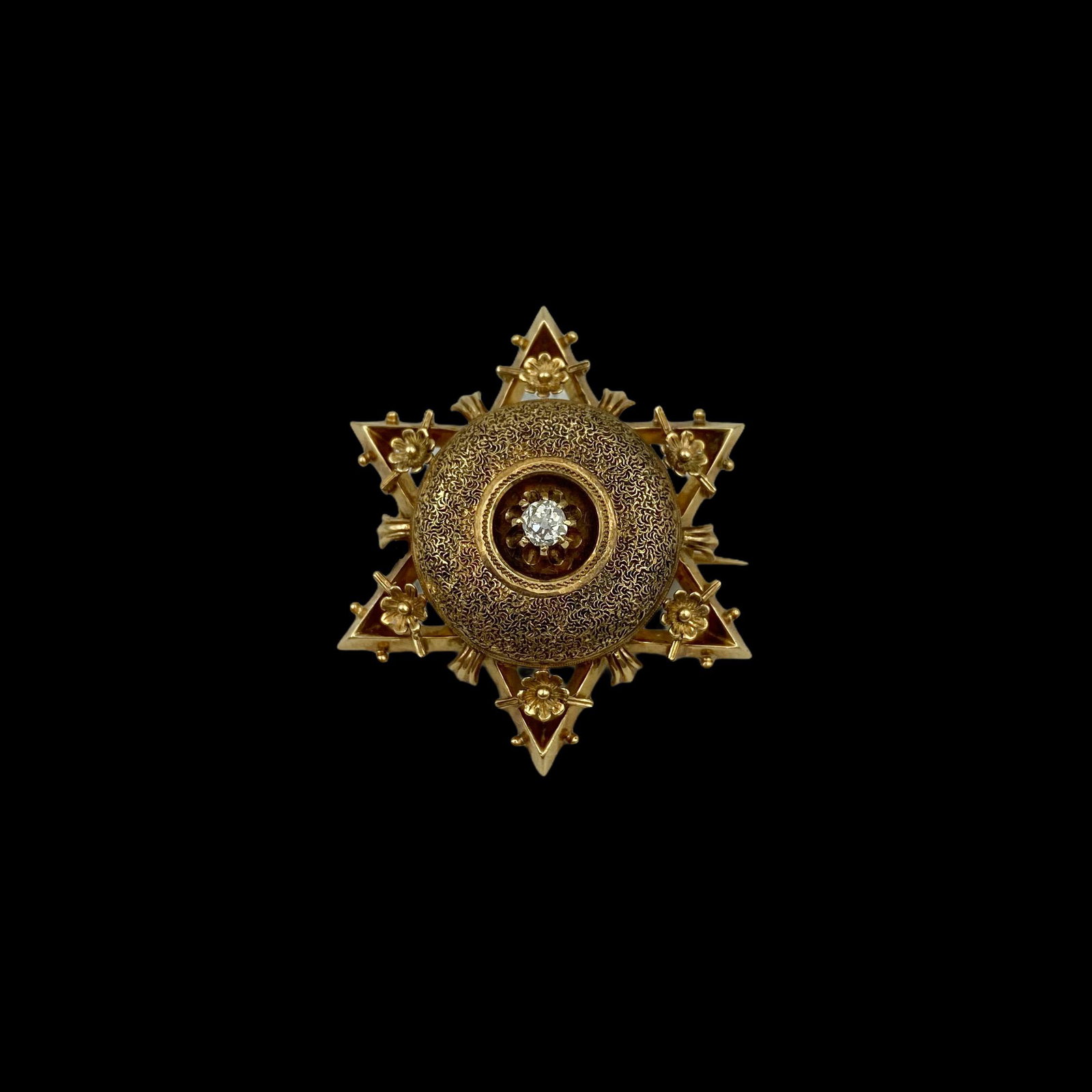 Victorian Gold Diamond Star Memorial Brooch: 14K. Elaborately decorated Six ponted star centered with a bright old mine cut diamond. Locket compartment on reverse with original beveled glass cover. Measures 1 1/4 in W. Excellent condition. Weigh