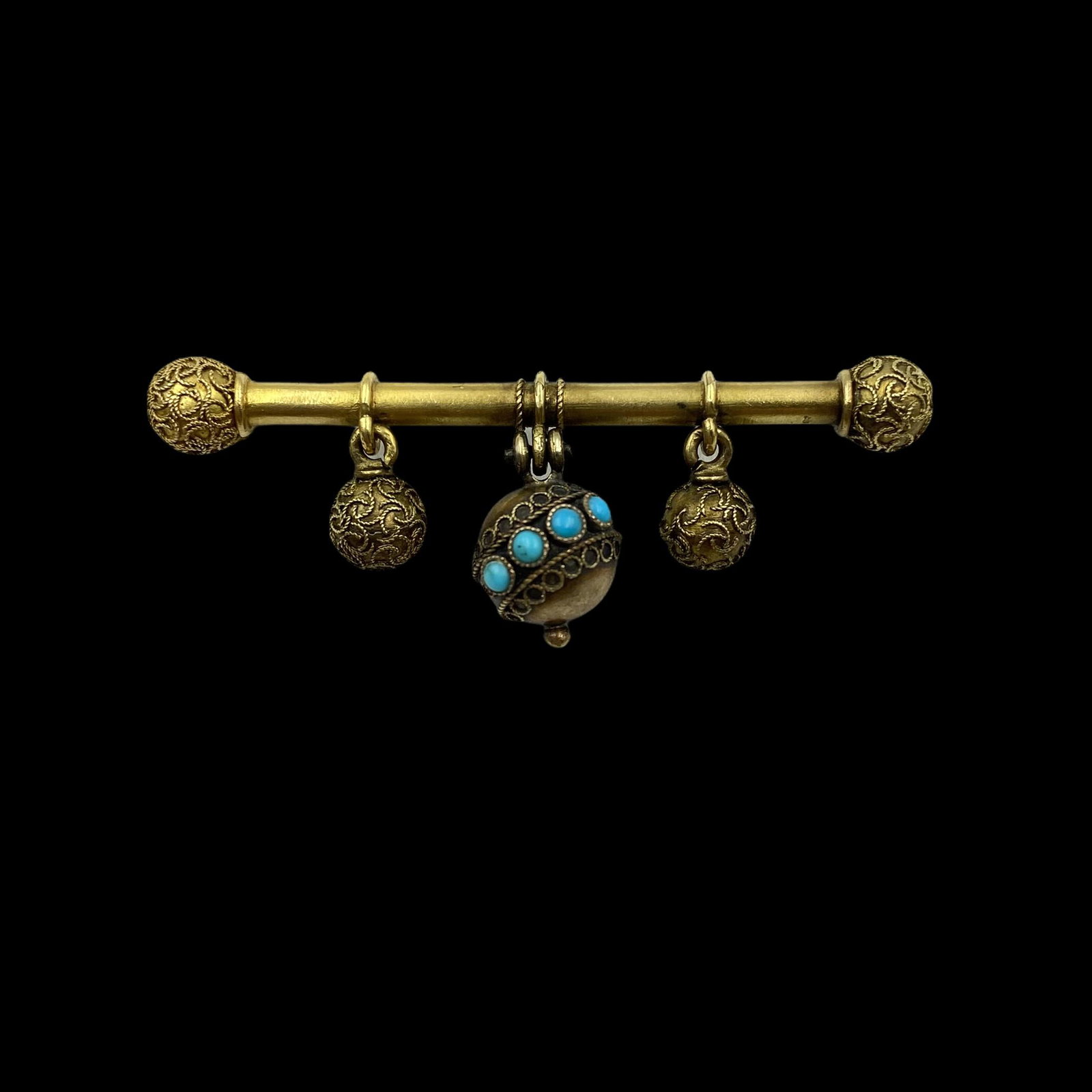 15K Etruscan Revival Turquoise Brooch: Circa 1900 solid gold bar pin set with turquoise and Etruscan Revival decoration. Measures 1 3/4in L. Weight 3.6g. Excellent condition
