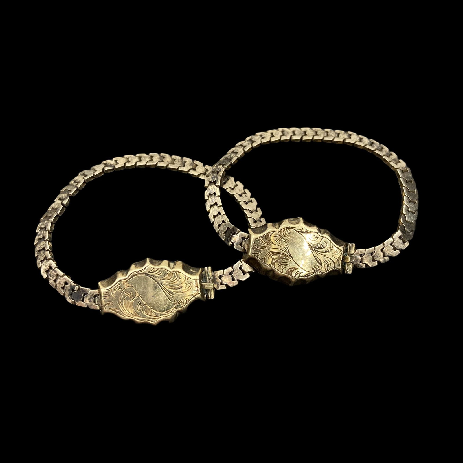 14K Pair Victorian Baby Bracelets: With hand chased decoration on the clasp and flat chain link bracelet. Measure 4in L. Combined weight 4g. Rare find! Excellent condition.
