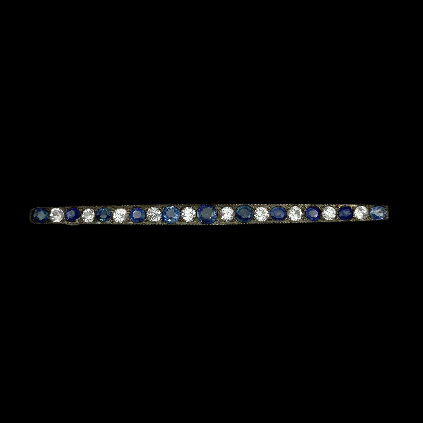 Edwardian Sapphire Bar Pin: With natural white and blue Sapphires set in silver. Measures 2 1/2in L. Sapphires Apx 2 CTWWeight 3.2g