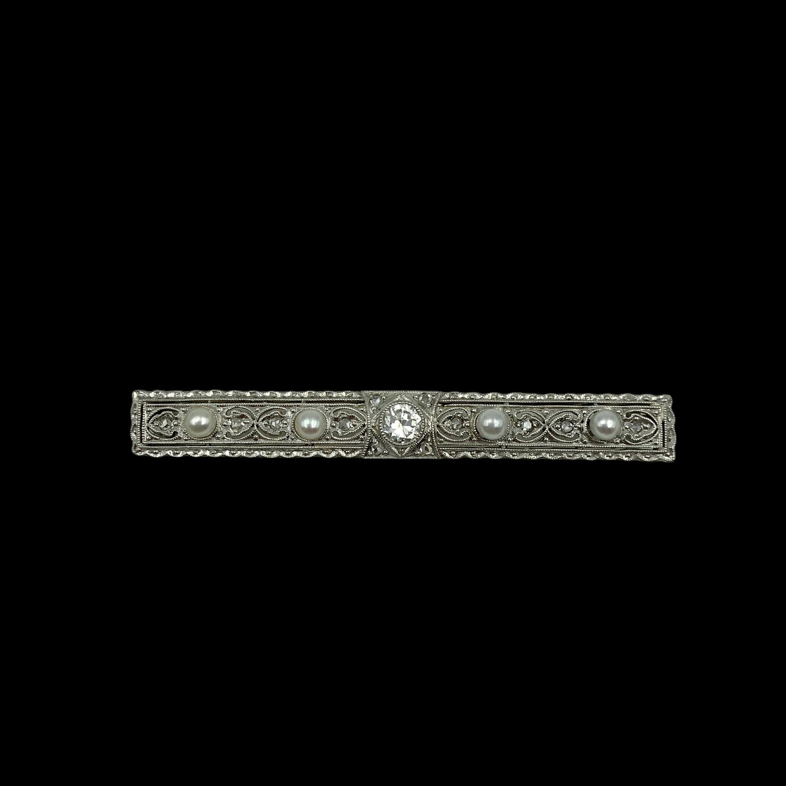 18K Edwardian Diamond Pearl Pin: Transitional cut diamonds and natural pearls. Lovely pierced designs throughout and delicate border details. Measures 1 7/8 L and 6mm wide. Weight 3.7g Excellent condition.