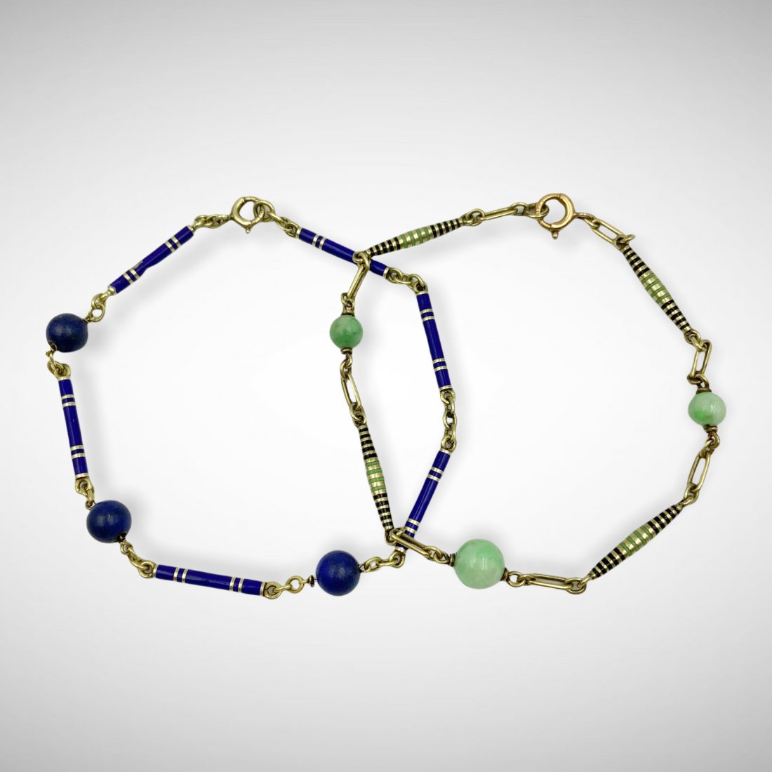 Pair of 14k Art Deco Enamel Bracelets: Pair of quintessential Art Deco enamel link bracelets in 14k gold. One bracelet with green and black striped links alternating with jade beads. The other with royal blue striped links alternating with