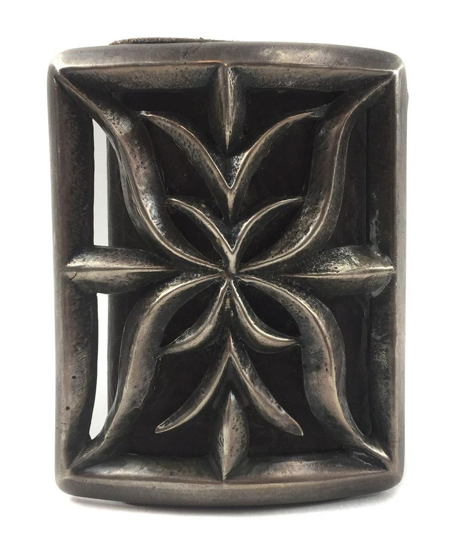 Navajo Silver Sandcast Ketoh with Original Leather: Navajo Silver Sandcast Ketoh with Original Leather c. 1920s. 224.5 grams, 3.625" x 2.875" face. The four holes at each end are original, and are used to lace a strap through. Ex H. Claiborne Lockett (