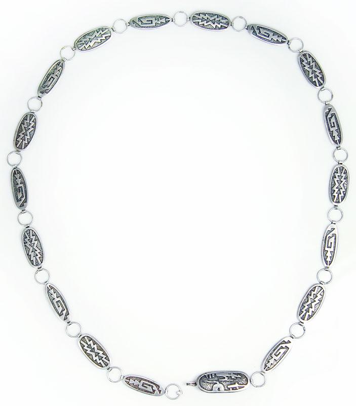 Gibson Gene - Navajo Sterling Silver Overlay Concho: Gibson Gene - Navajo Sterling Silver Overlay Concho Belt c. 1970s. 74.1g, fits a waist size of up to 33"; each concho measures 0.625" x 1.25". Hallmarked by the artist. Acquired from a private collect
