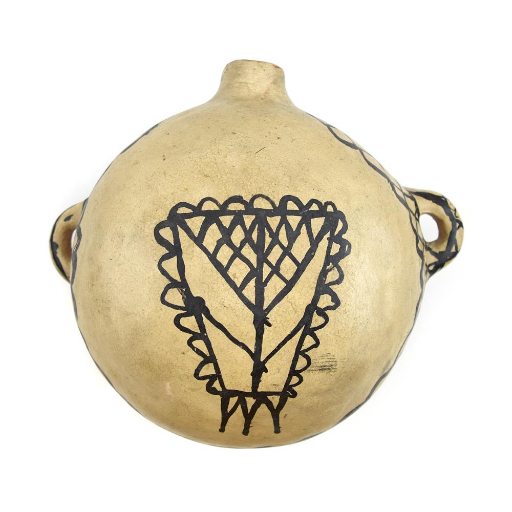 Cochiti Canteen c. 1890s, 7" x 9" x 5": White slipped body with black geometric design around its circumference and on side handles, and a beautiful old shield design on the front. Acquired from a collection in Colorado.
