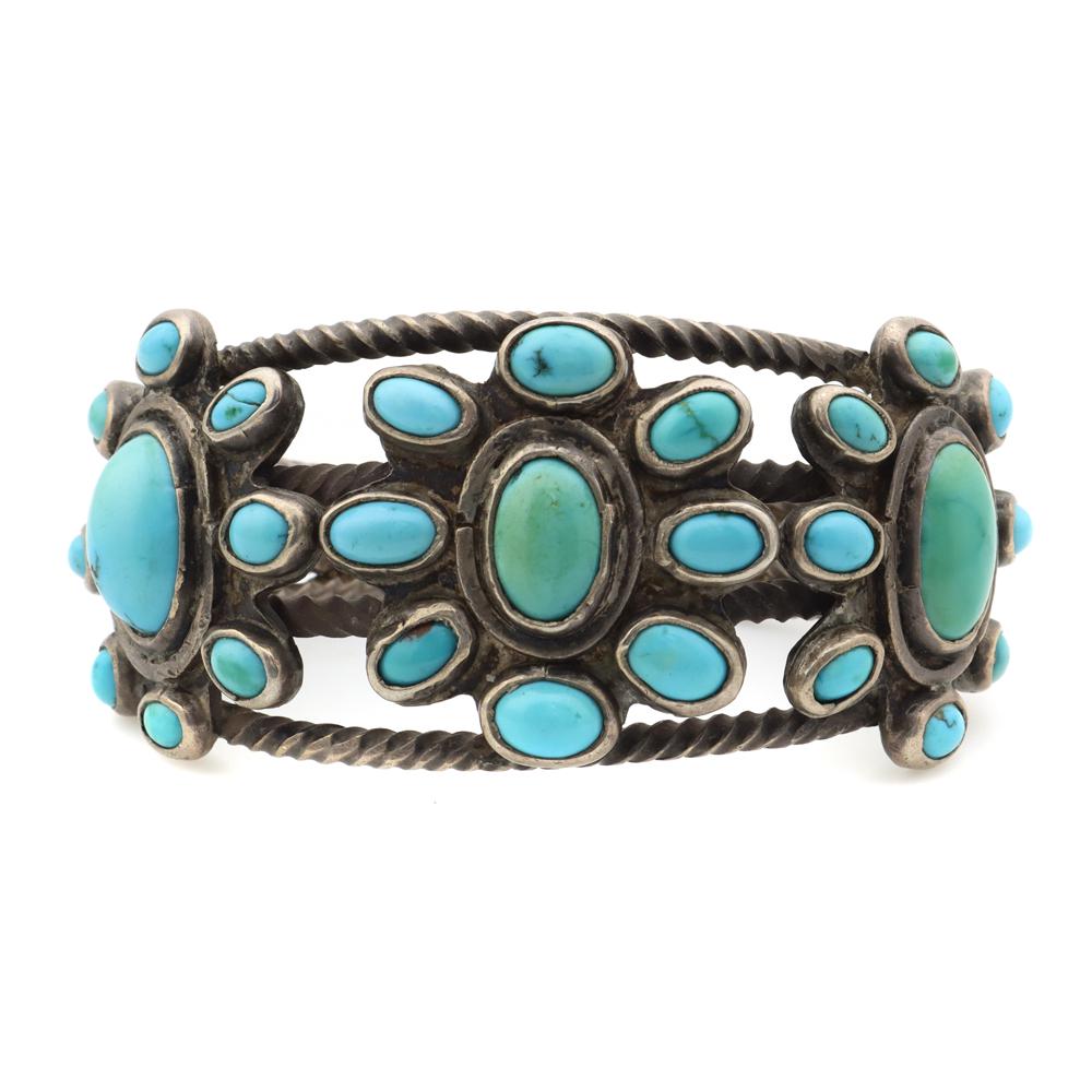 Navajo Turquoise Bracelet, Ex Pockels collection: Navajo Turquoise and Silver Bracelet c. 1920s, Ex Pockels collection. 96.1 grams, 1.375" bandwidth, size 6.75 to include a gap of 1". This silver has acquired a nice, even patina, and the stones are s