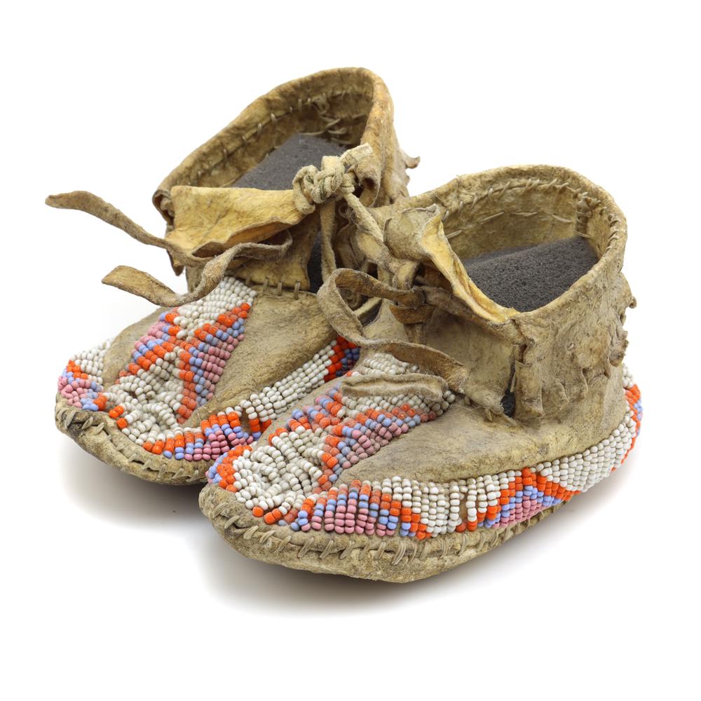 Sioux Beaded Baby Moccasins: Sioux Beaded Baby Moccasins c. 1900s, 2.5" x 2.5" x 4.5" each. The beadwork is in excellent condition, with no beadloss. The leather is in very good condition. It is sinew sewn, evenly woven along the