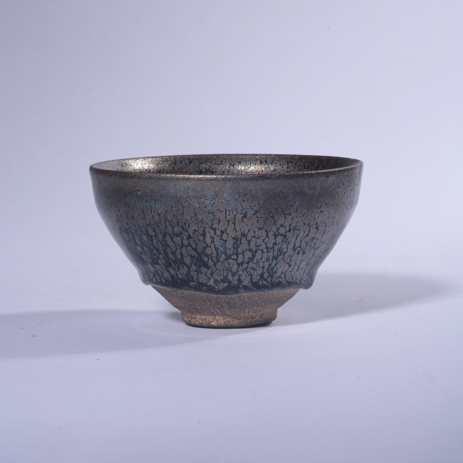 A Jian Kiln Moulded Porcelain Cup: A Jian Kiln Moulded Porcelain CupDiam.12.5cmï¼›Height:7.3cmï¼›From the collections of Benjamin Cheung (1962-2012). Born in GuangZhou, at age 15 immigrant to the United States and he has engage