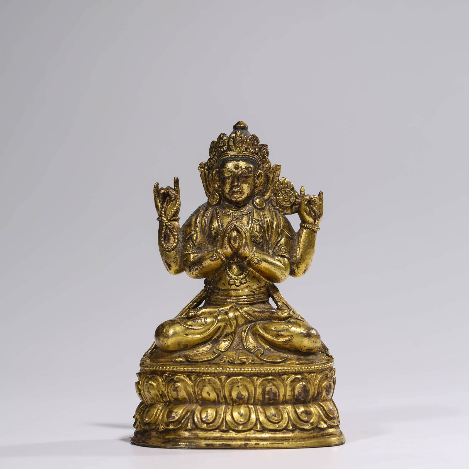 A GILT-BRONZE FOUR ARMED GUANYIN (1 of 9)