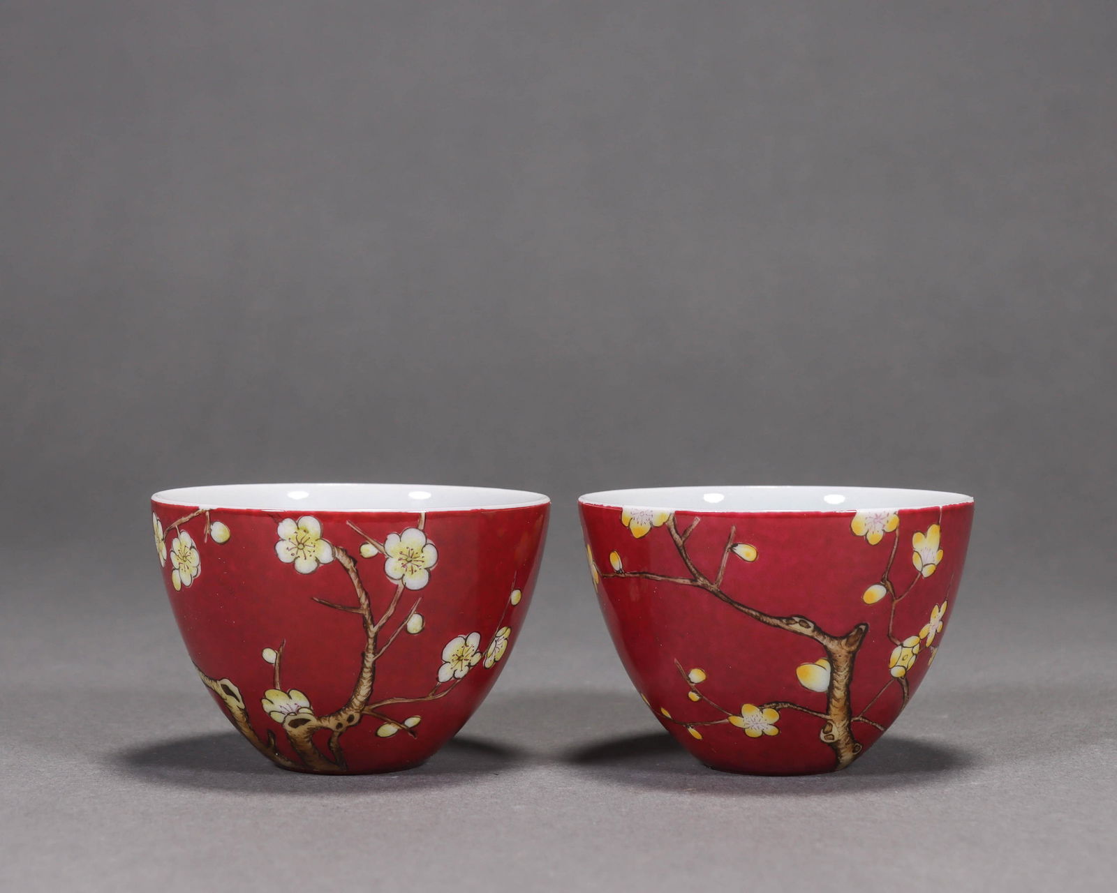 Pair Of Rouge-Red Glaze And Famille Rose Plum Blossom Cups: Pair Of Rouge-Red Glaze And Famille Rose Plum Blossom CupsHt.4.3cm, D.6.5cm,
