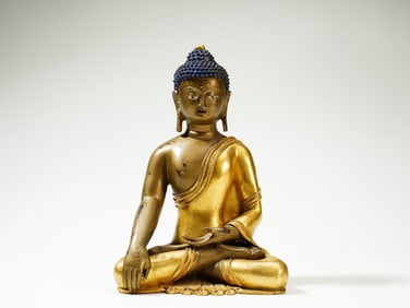 A GILT BRONZE FIGURE OF SHAKYAMUNI