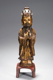 A GILT-LACQUERED COPPER ALLOY FIGURE OF OFFICIAL