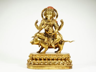 A GILT BRONZE FIGURE OF JAMBHALA