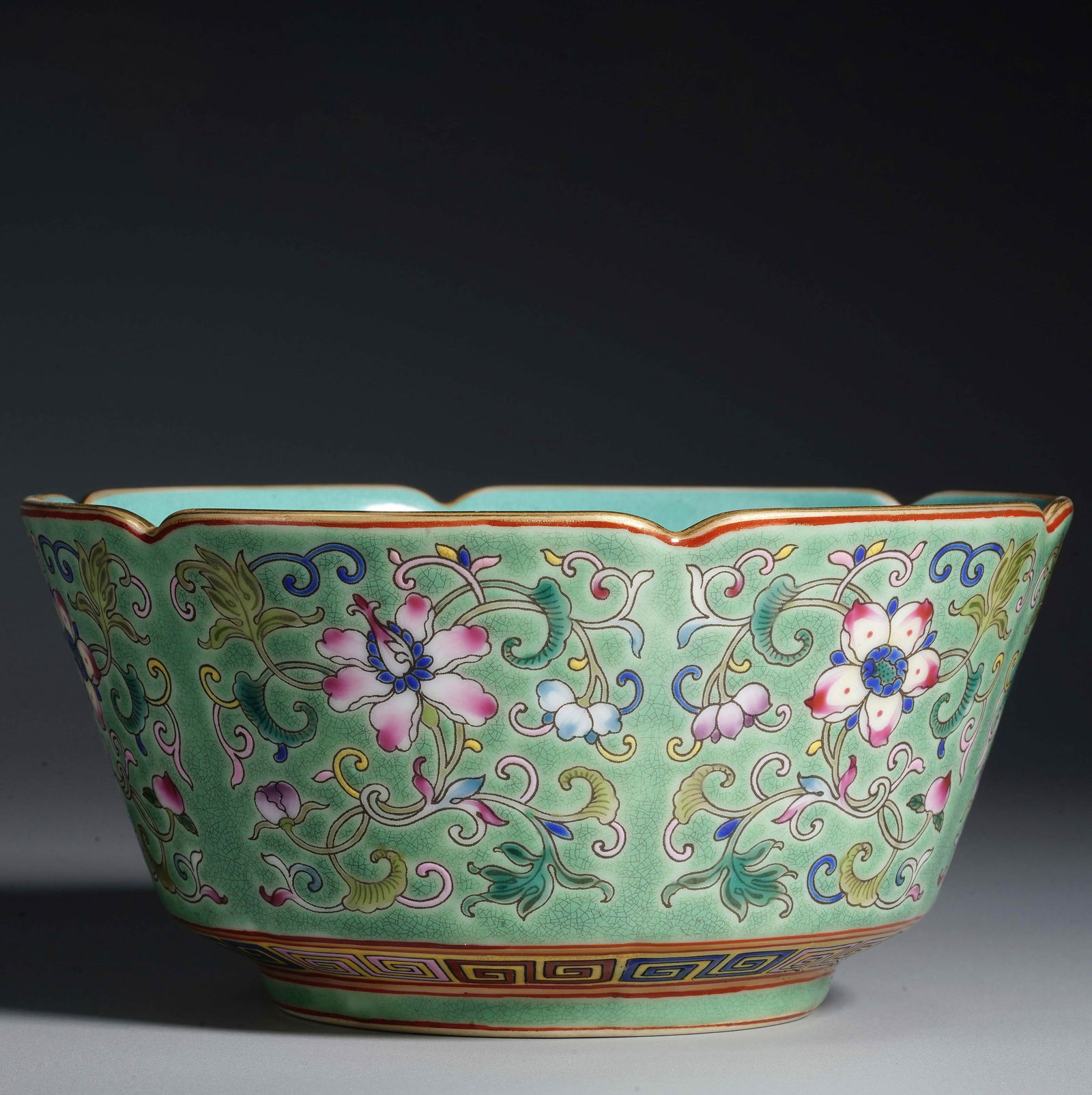 A Chinese famille rose bowl with flower mouth and scrolling floral patterns with turquoise glaze.: A Chinese famille rose bowl with flower mouth and scrolling floral patterns with turquoise glaze. Diameter: 5 7/8 in. (15 cm), Height: 2 15/16 in. (7.5 cm).