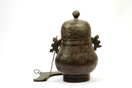 A BRONZE BEAST FACE HANDLED VASE