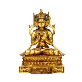A GILT BRONZE FIGURE OF TRIPLE FACED BUDDA