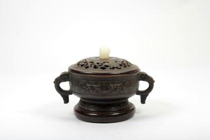 A BRONZE BEAST FACE INCENSE BURNER