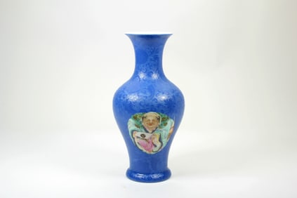 A BLUE GROUND FAMILLE ROSE 'FIGURAL'GUANYIN VASE