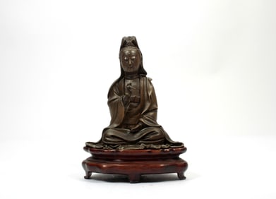 A BRONZE FIGURE OF GUANYING