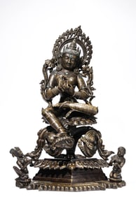 A Tibetan Pala Dynasty Copper and Silver Inlaid Green Tara Statue