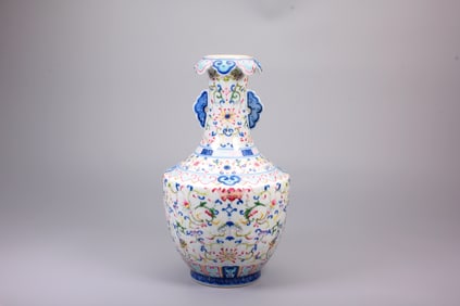 A BLUE AND WHITE FAMILLE ROSE HANDLED VASE