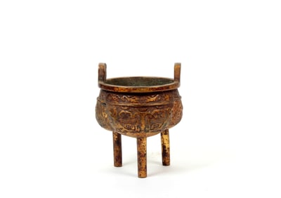 A GILT BRONZE TRI-POD INCENSE BURNER