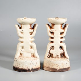A PAIR OF WHITE GLAZED CANDLE STANDS