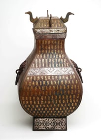 A GOLD AND SILVER-INLAID VASE