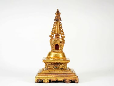 A GILT BRONZE FIGURE OF SCHIST RELIQUARY PAGODA
