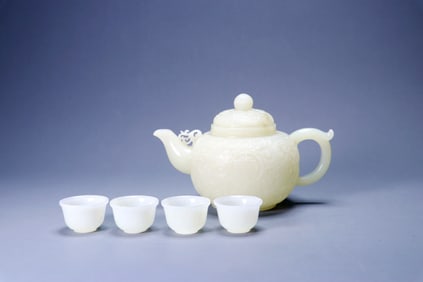 A HETIAN JADE 'LOTUS' TEAPOT AND CUPS