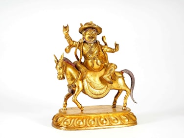 A GILT BRONZE FIGURE OF JAMBHALA RIDING UPON A HORSE