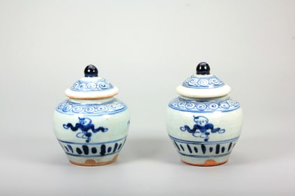 A PAIR OF BLUE AND WHITE 'BOYS'JARS AND COVERS