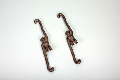 A PAIR OF IRON MONKEY ORNAMENTS